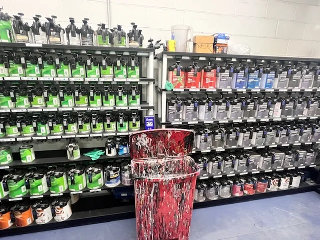 Heritage paint mixing room with full Sikkens automotive refinish system, hundreds of tint cans on dedicated shelving