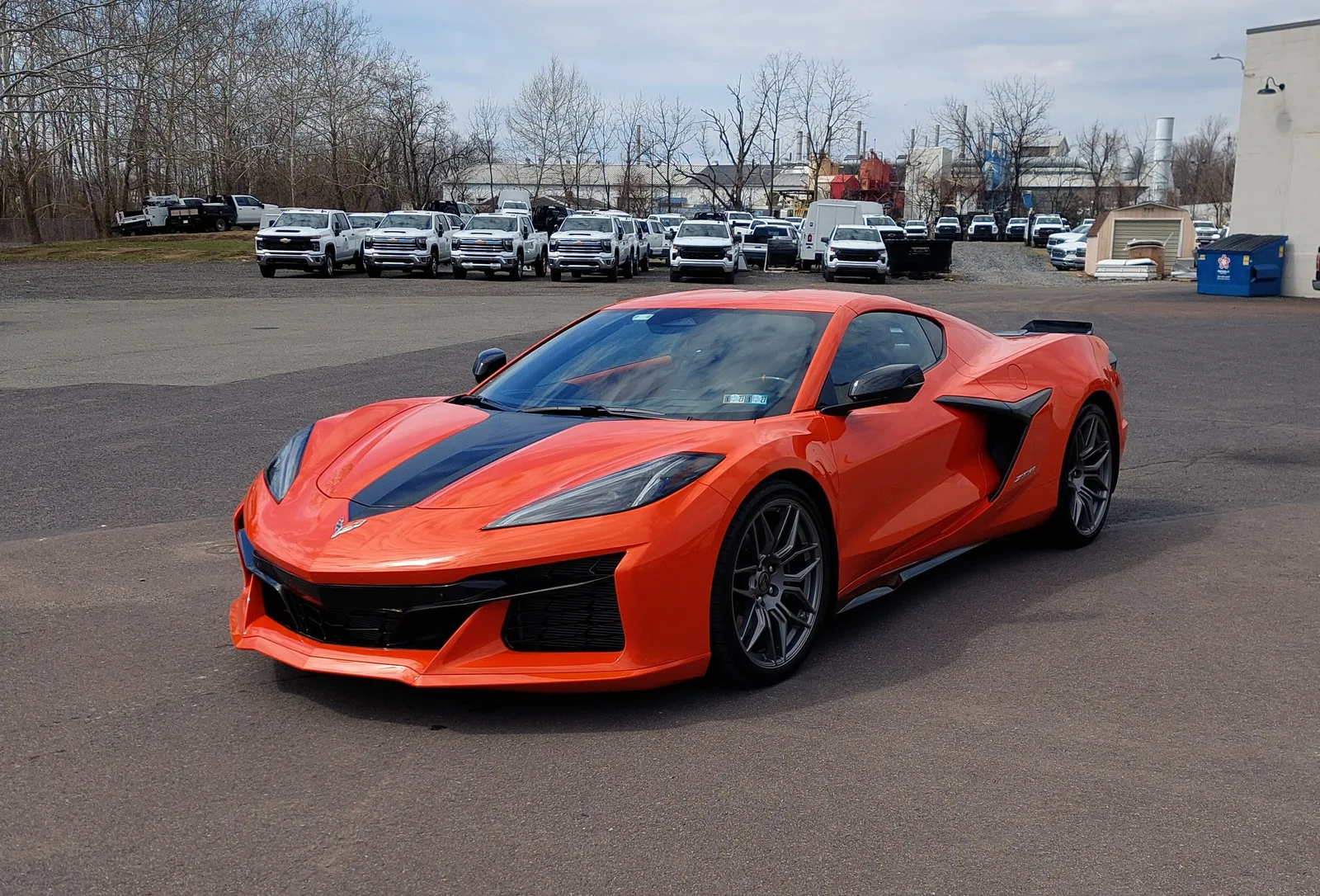 Amplify Orange Chevrolet Corvette C8 Z06 front three-quarter outdoors, deep gloss finish