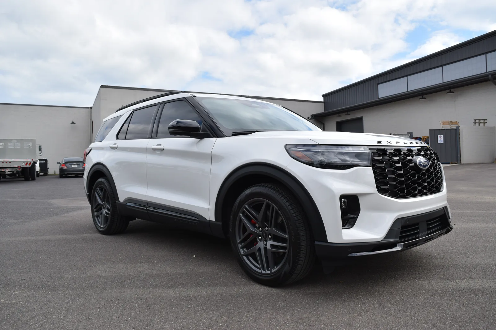 White Ford Explorer ST front three-quarter outdoors at the Heritage shop, gloss white finish